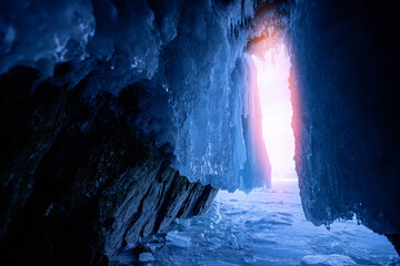 Blue ice cave grotto lake Baikal Olkhon island, Russia. Frozen clear icicles, beautiful winter landscape