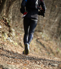 athlete running during a cross-country foot race on a path