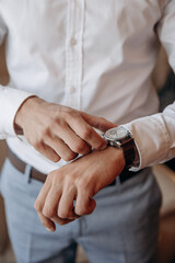 Obraz premium Style man portrait with touching the watch