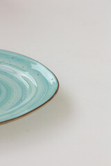 Powder-blue plate, turquoise-colored plate isolated on white background. Mock up, copy  space