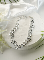 Fashion bijouterie - large silver chain bracelet on a white stand