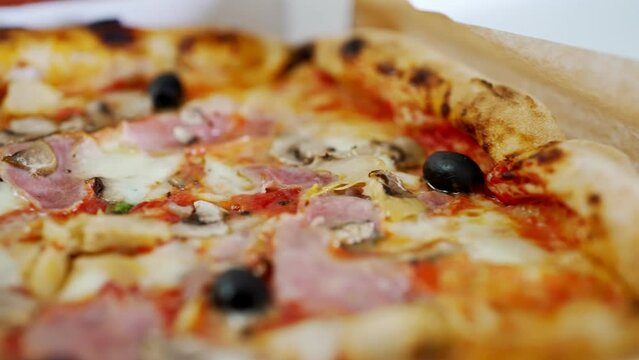 Pizza capricciosa. Pizza with ham, olives, mushrooms and artichokes.