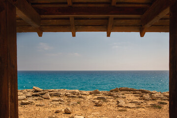 Seascape Cape Greco peninsula park in wooden frame, Cyprus.