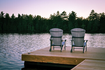 Back view of chairs in the wooden dock on the lake