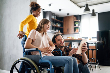 Happy multiethnic family with child with disability in wheelchair