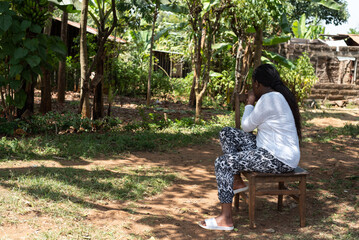 Portrait of a teenage African Girl sitting in the garden