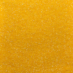Photo of closeup texture of yellow milled maize cereals, background