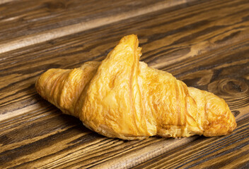 Croissant wooden table close-up.