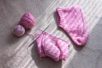 Fototapeta na wymiar Pink knitted socks. Hobby relax concept.