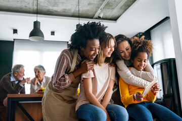 Happy lesbian multiethnic couple in love with childen at home. Family lgbt child happiness concept