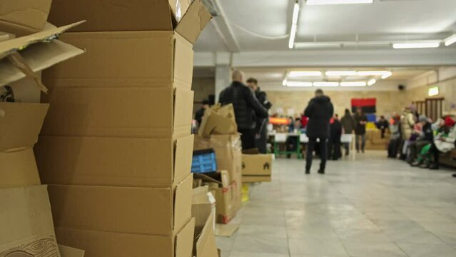 Logistics center for sending cargo in support of ukrainian soldiers in russia's war against ukraine. Lots of boxes of products from volunteers. Blurred background.