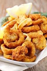 Fried squid rings breaded with lemon on a plate