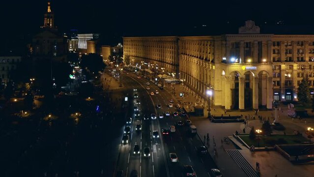 Aerial top view of moderate car traffic at night in the city.
