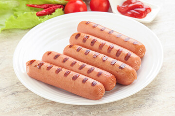 Grilled sausages with tomato sauce