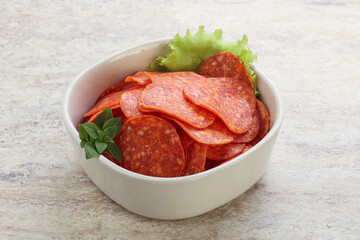 Sliced pepperoni sausage in the bowl