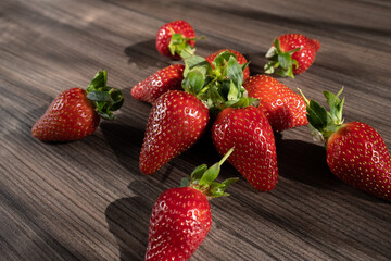 Star made from fresh and ripe strawberries. Beautiful presentation of food for children. Summer background with sunbeams and freshness. High quality photo