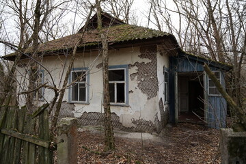 Fototapeta na wymiar Abandoned damaged house in Chernobyl exclusion zone surrounding nuclear power plant with high radioactive contamination, Chernobyl, Ukraine