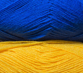 Ukrainian national colors. Ukraine patriotism. Blue and yellow colors. Ukrainian flag. Colorful threads. Hobby concept. Woolen yarn. Patriotic design.