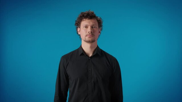 Stylish male showing mouth on zip lock quiet silence don't speak gesture shaking head posing