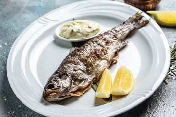 Grilled Fresh sea bass. Mediterranean fish, baked with herbs and lemon. banner, menu, recipe place for text, top view