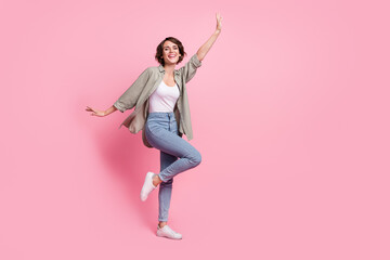 Full body photo of dynamic lady dancing discotheque music lover raise arms up isolated pastel color...