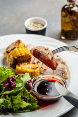 Green salad with chicken breast, grilled corn and sauce. Healthy fats, clean eating for weight loss