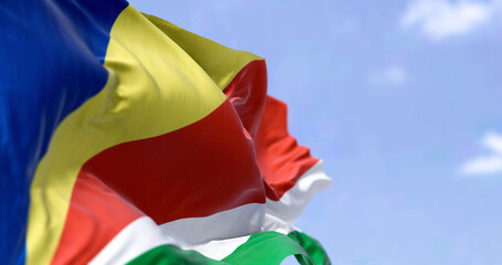 Detail of the national flag of Seychelles waving in the wind on a clear day.
