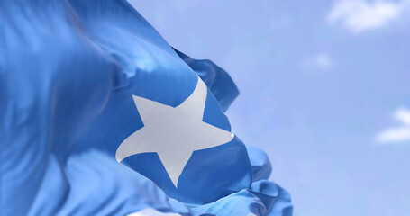 Detail of the national flag of Somalia waving in the wind on a clear day - obrazy, fototapety, plakaty