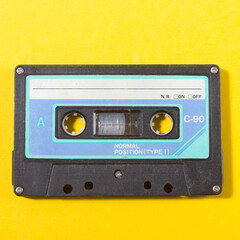 retro audio compact cassette on a yellow background