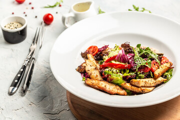 Healthy green salad with grilled chicken breast and sauce, Delicious balanced Healthy food, keto diet, diet lunch concept. Top view