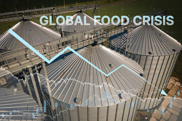 Grain storage silos. Galvanized tanks for grain with graph with arrow trending downwards, Global food crisis after Embargo and sanction for export. Global food security