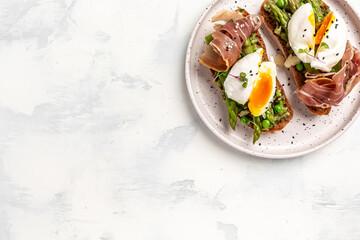 Ketogenic diet meal Poached egg with asparagus spears and prosciutto. banner, menu recipe place for text, top view