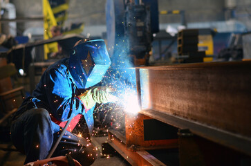 A welder works at a factory	
