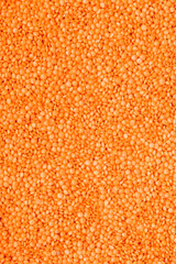 Scattered raw red lentils as background texture