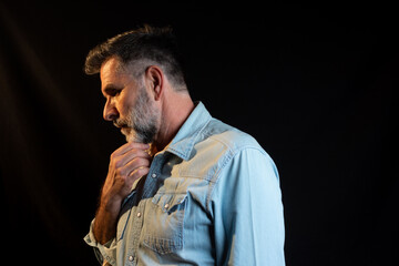 Side view of smiling mature unshaven business man in light shirt posing isolated on grey wall...