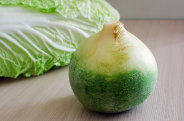 Green radish and Beijing cabbage lie on the table. Healthy food, natural vitamins.
