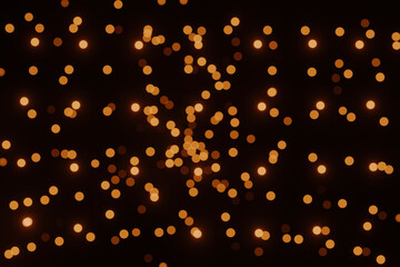 Defocused bokeh lights on black background, an abstract naturally blurred backdrop for Christmas eve or birthday party. Festive light texture. Yellow and red garland in blur. Overlay effect for design