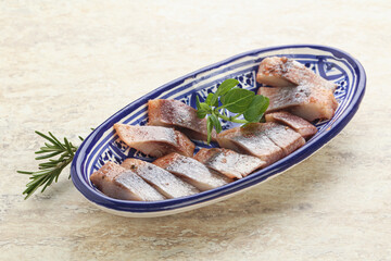 Delicous sliced herring fillet in grape sauce