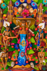 Catrina made of clay and colored, traditional Mexican popular character, accompanied by skeleton musicians.