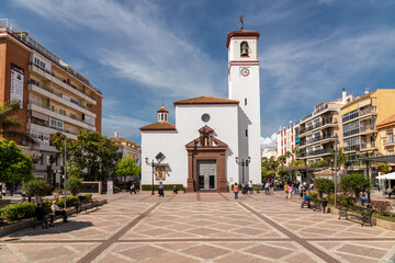 Constitution Square in the center of Fuengirola city with view of the Church "Nuestra Señora del Rosario". Famous plaza in old town center of the city.
