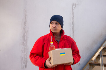 Volunteer preparing food box for ukrainian war refugees - Humanitarian help and aid concept