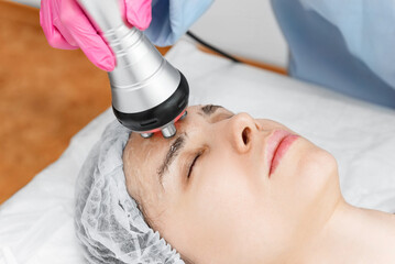 Radio wave face lifting in a cosmetology clinic photo. Skin treatment. Hardware cosmetology.