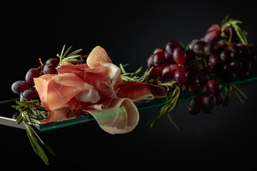 Prosciutto with rosemary and grapes.