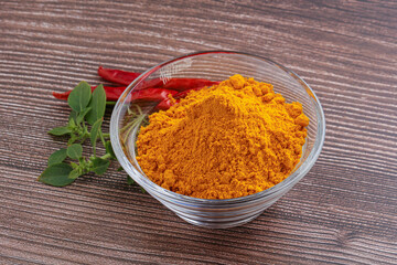 Yellow vibrant curcuma powder in the bowl