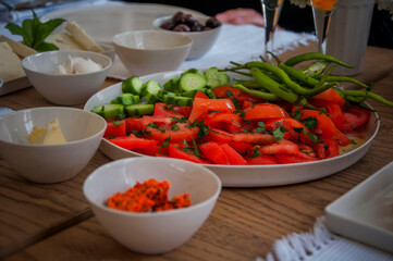 Mediterranean breakfast with fresh colorful vegetables on wooden table, front view