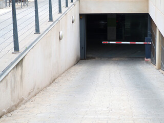 Subterranean car parking entrance ramp with horizontal barrier