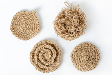 Natural washcloth made of craft thread for washing dishes. The concept of waste-free production , zero waste on white background isolated 