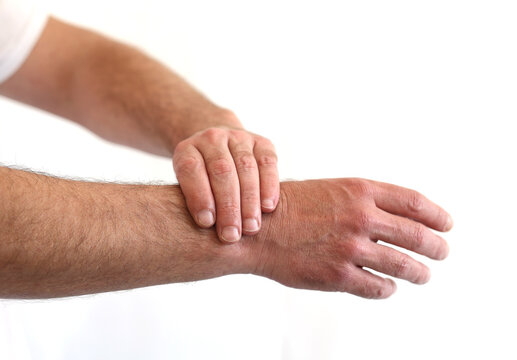 Man holding the wrist with pain isolated on white , Dorsal wrist syndrome pain in distal intersection syndrome.