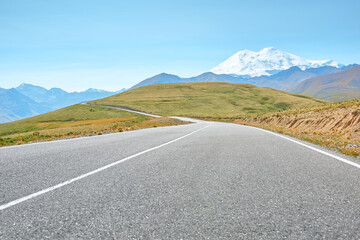 A winding mountain road to the Djily Su tract with beautiful views of the Elbrus peaks. Spring in the Caucasus.
