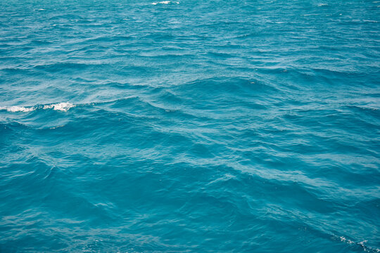 Abstract natural background, surface, texture. Waves of blue sea water. Copy space. Selective focus. © Marina_Nov